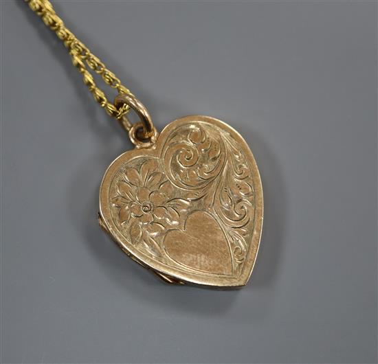 A 9ct gold heart-shaped locket on fancy gold chain (tests as 14ct).